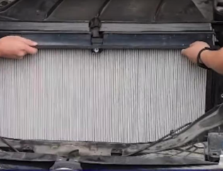 technicians install a tesla HEPA filter made by PUREFLOW